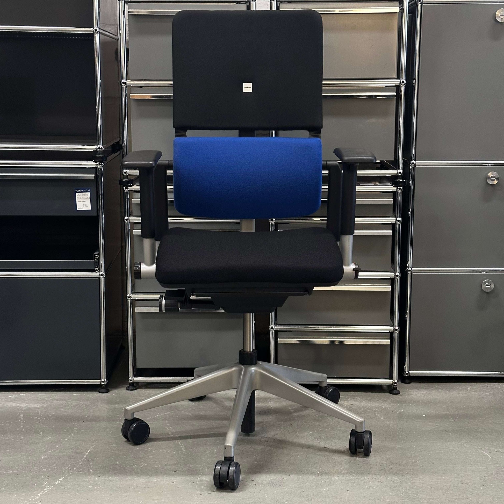 Ergonomic Steelcase Please office chair with black and blue cushions and adjustable armrests on a five-wheel base