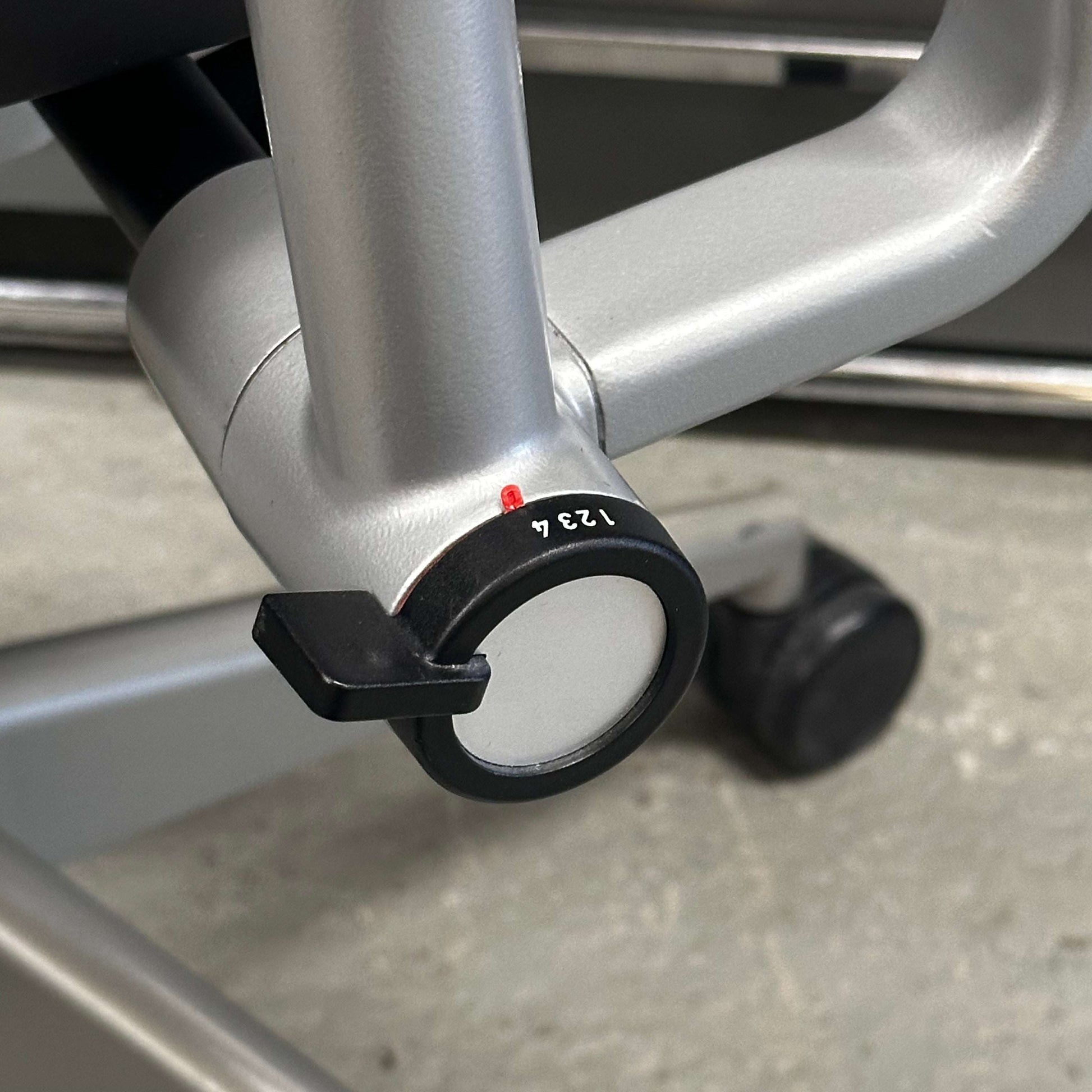 Close-up of Steelcase Please ergonomic office chair adjustment lever and metal frame detailing