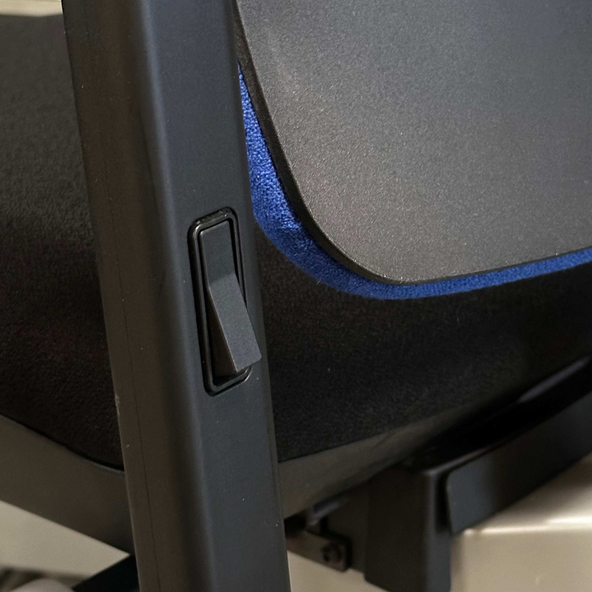 Close-up of adjustable lever and fabric detail on Steelcase Please ergonomic office chair