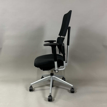 Steelcase Please ergonomic office chair in black with silver frame and adjustable armrests, lumbar support, and height-adjustable backrest