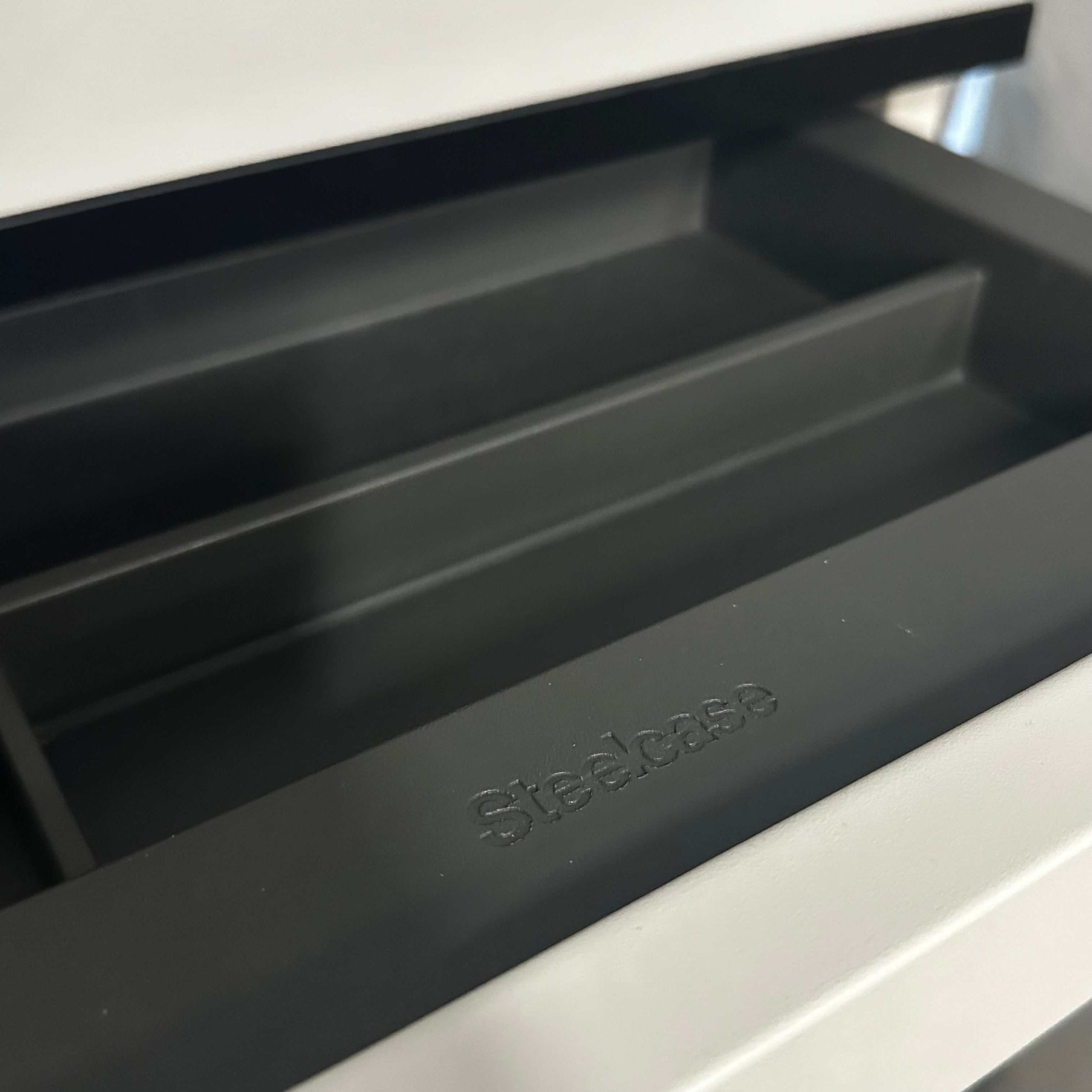 Steelcase Rollcontainer white with black edge close-up of open drawer compartments