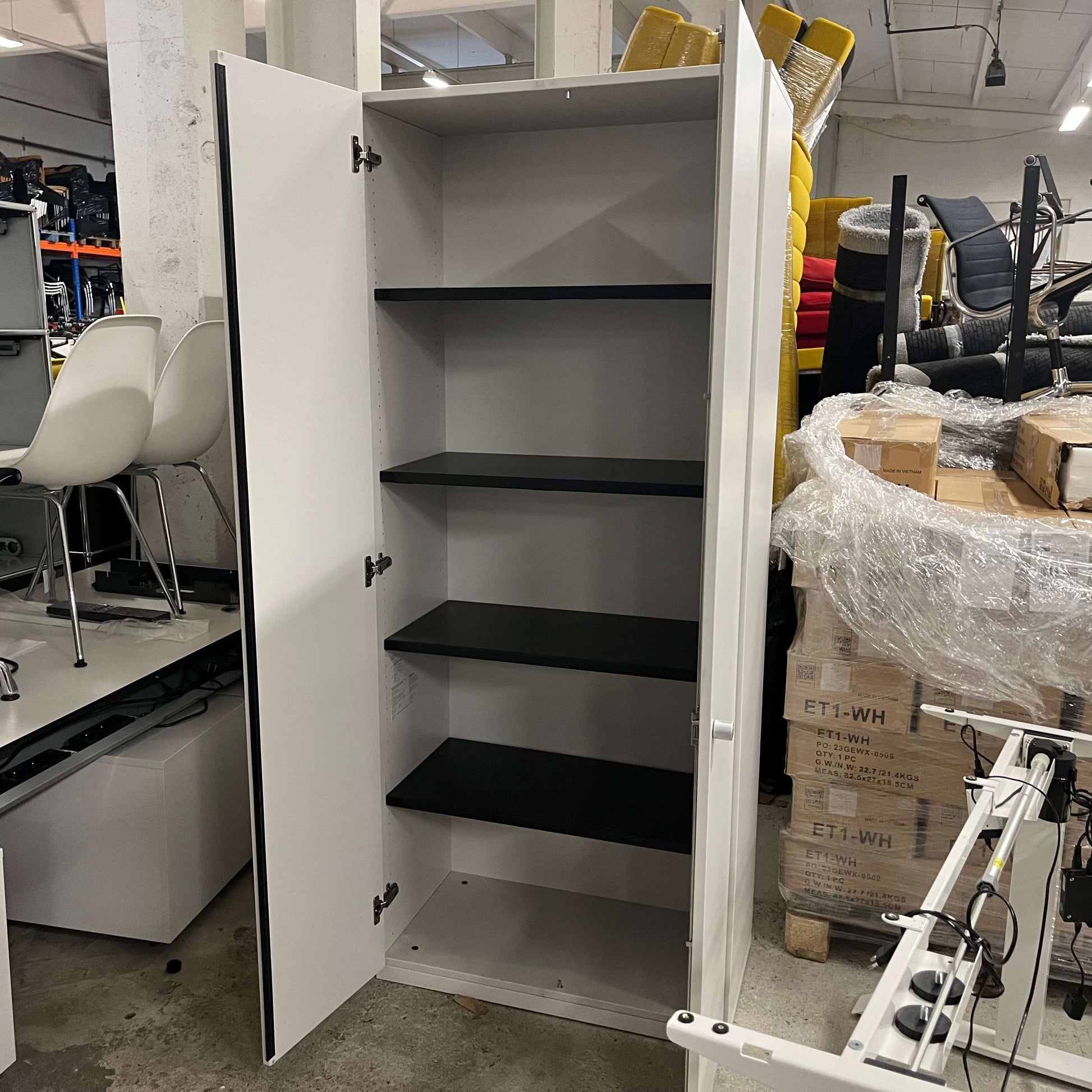 Steelcase Schrank grey cabinet with black shelves open in storage room