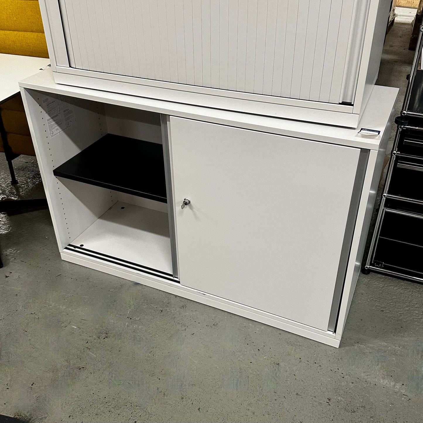 White Steelcase Sideboard 120cm wide with sliding doors and interior shelves in office setting