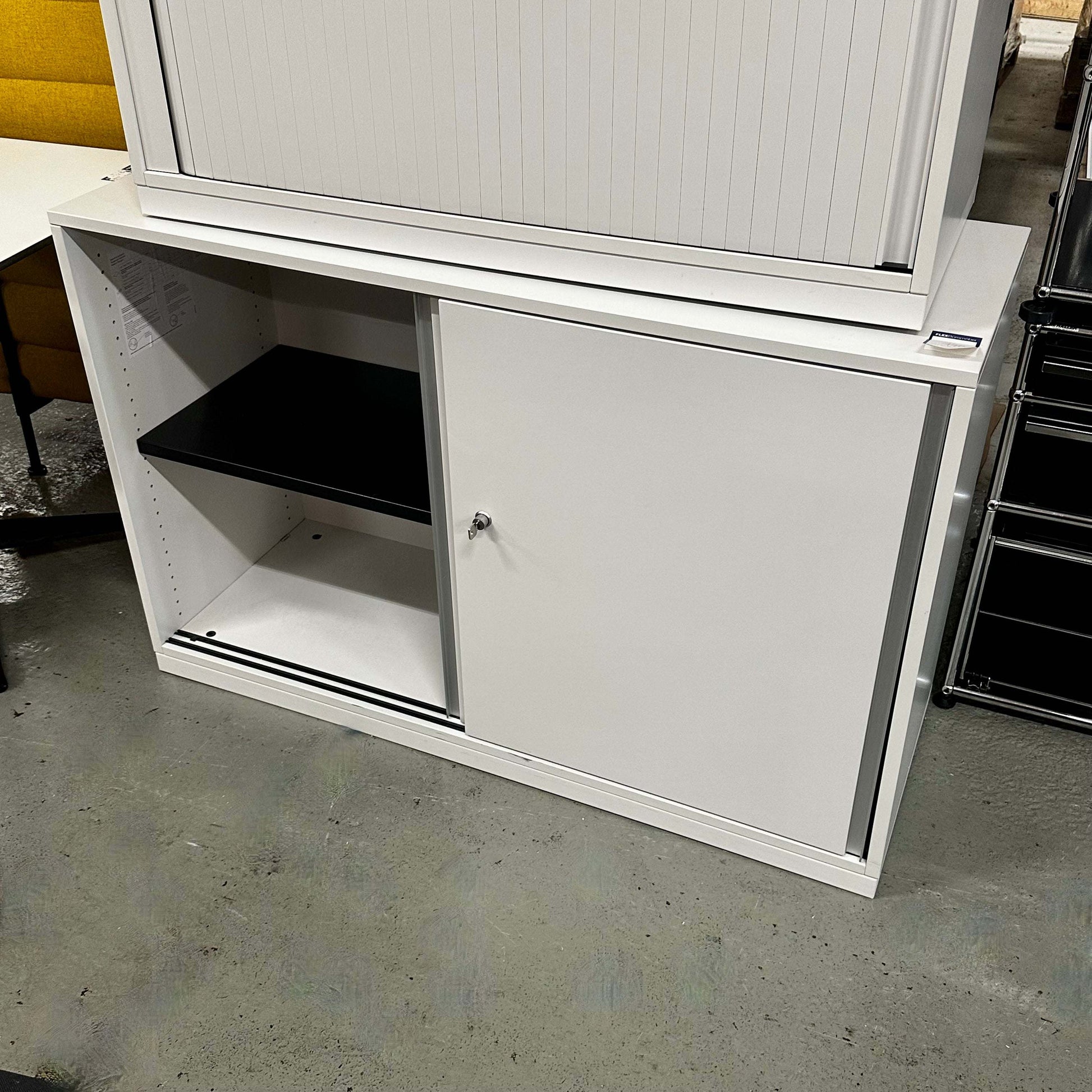 White Steelcase Sideboard 120cm wide with sliding doors and interior shelves in office setting