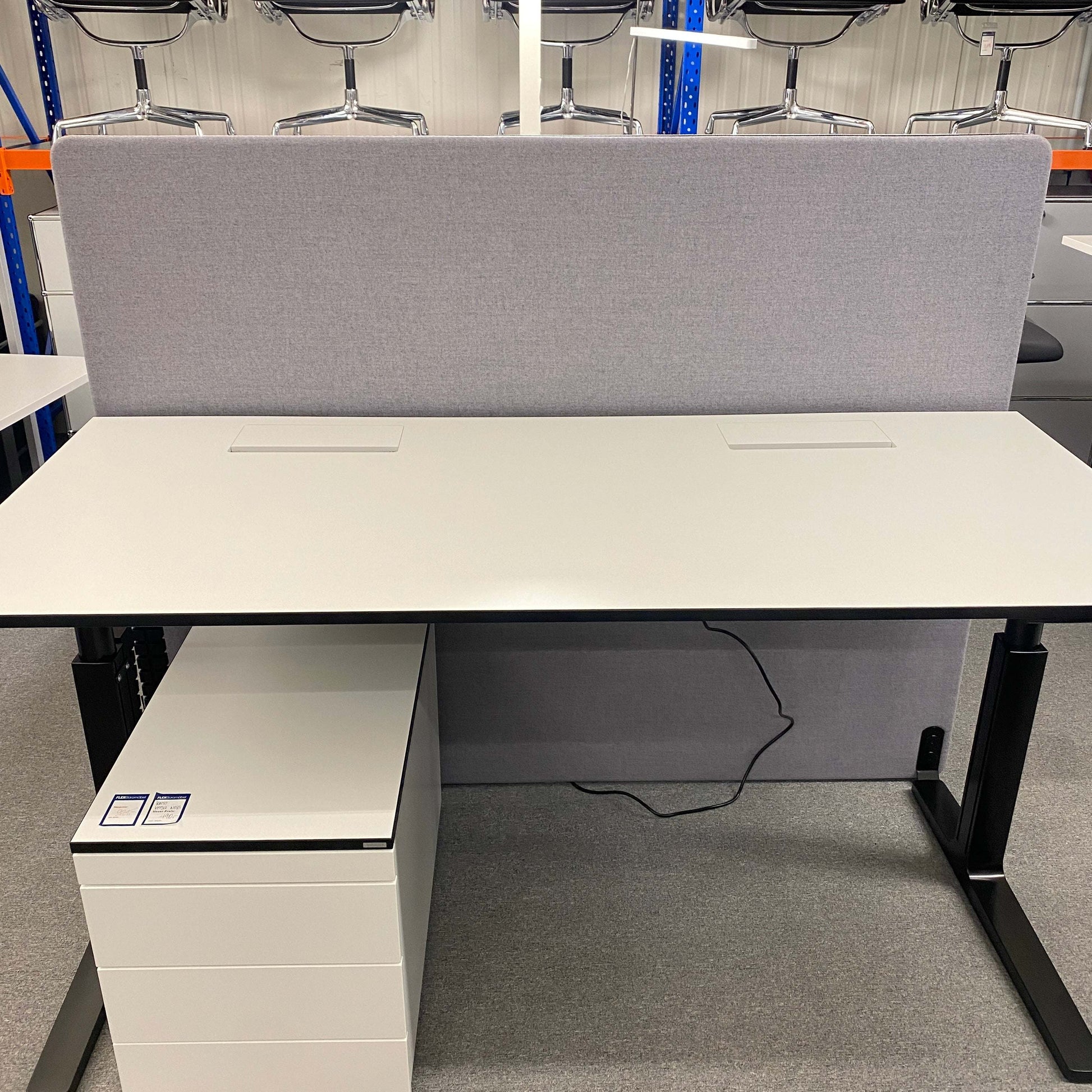 Grey fabric office partition screen 180x140 cm with black base under a white desk in a workspace setting