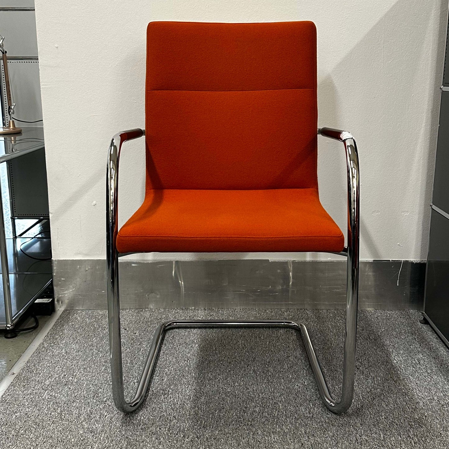 Thonet S60 chair with chrome frame and deep orange upholstery, stackable design