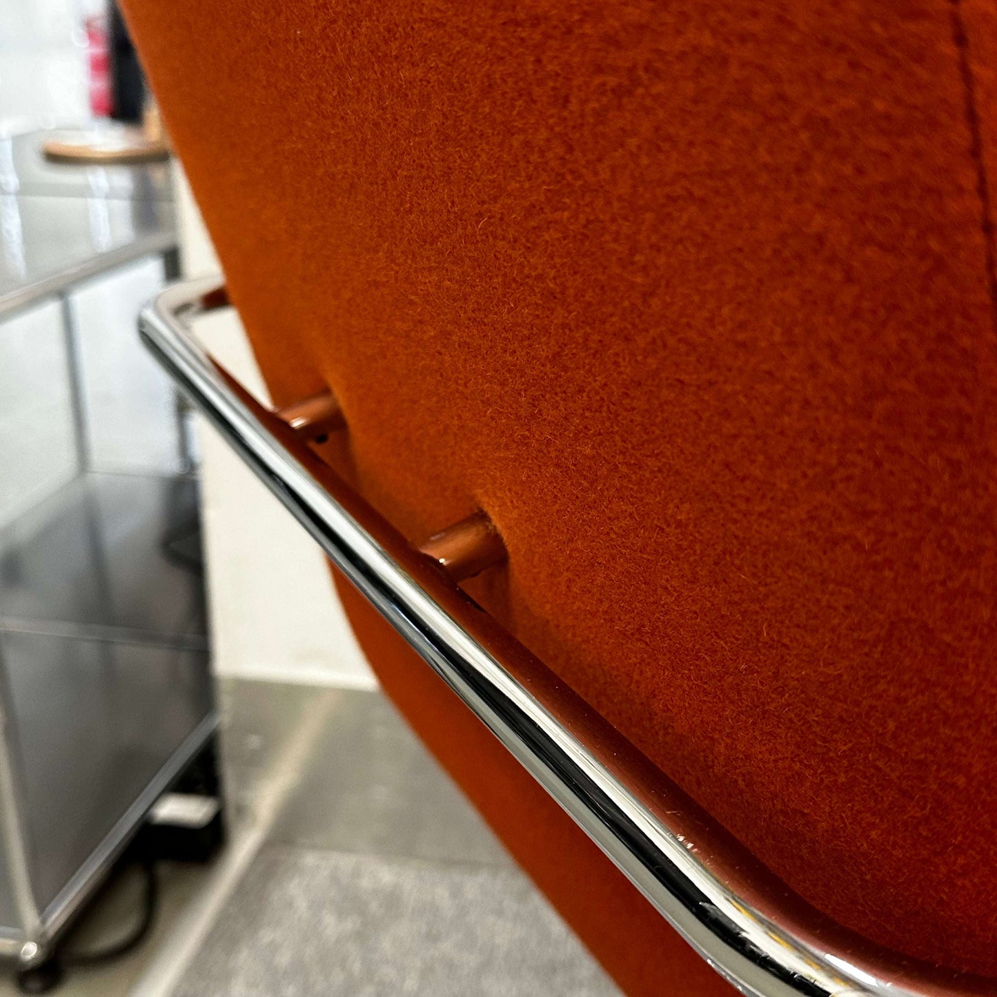 Thonet S60 chair with chrome frame and deep orange fabric, stackable design
