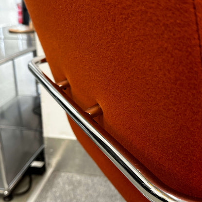 Thonet S60 chair with chrome frame and deep orange fabric, stackable design