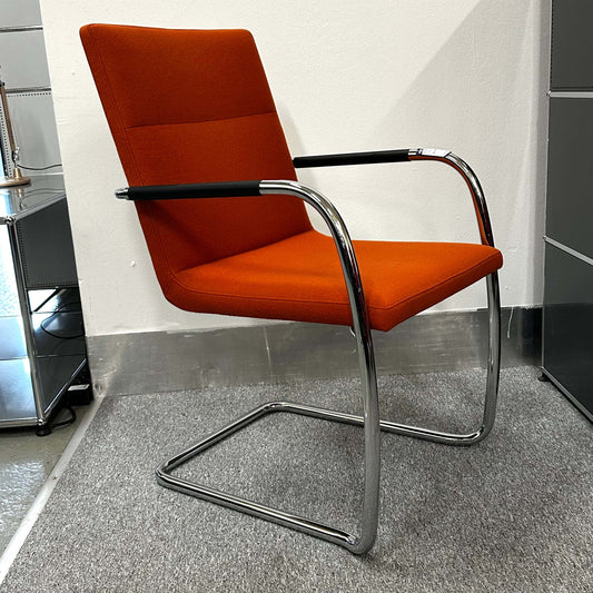 Thonet S60 chair with chrome frame and deep orange upholstery, stackable design