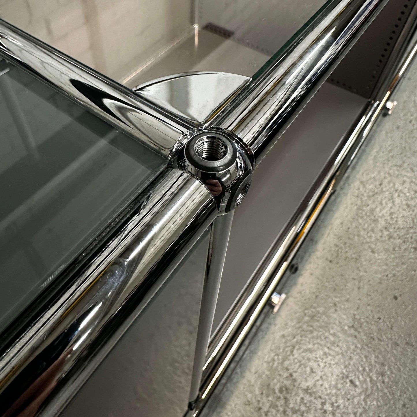 Detailaufnahme des USM Haller E Highboards mit verchromten Rohren und e-Kugel-Verbindungssystem