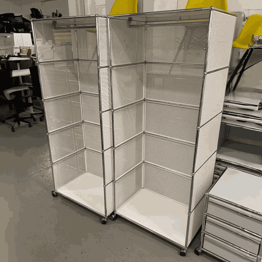 USM Haller Garderobe white modular shelving unit with chrome frame and mesh panels on wheels