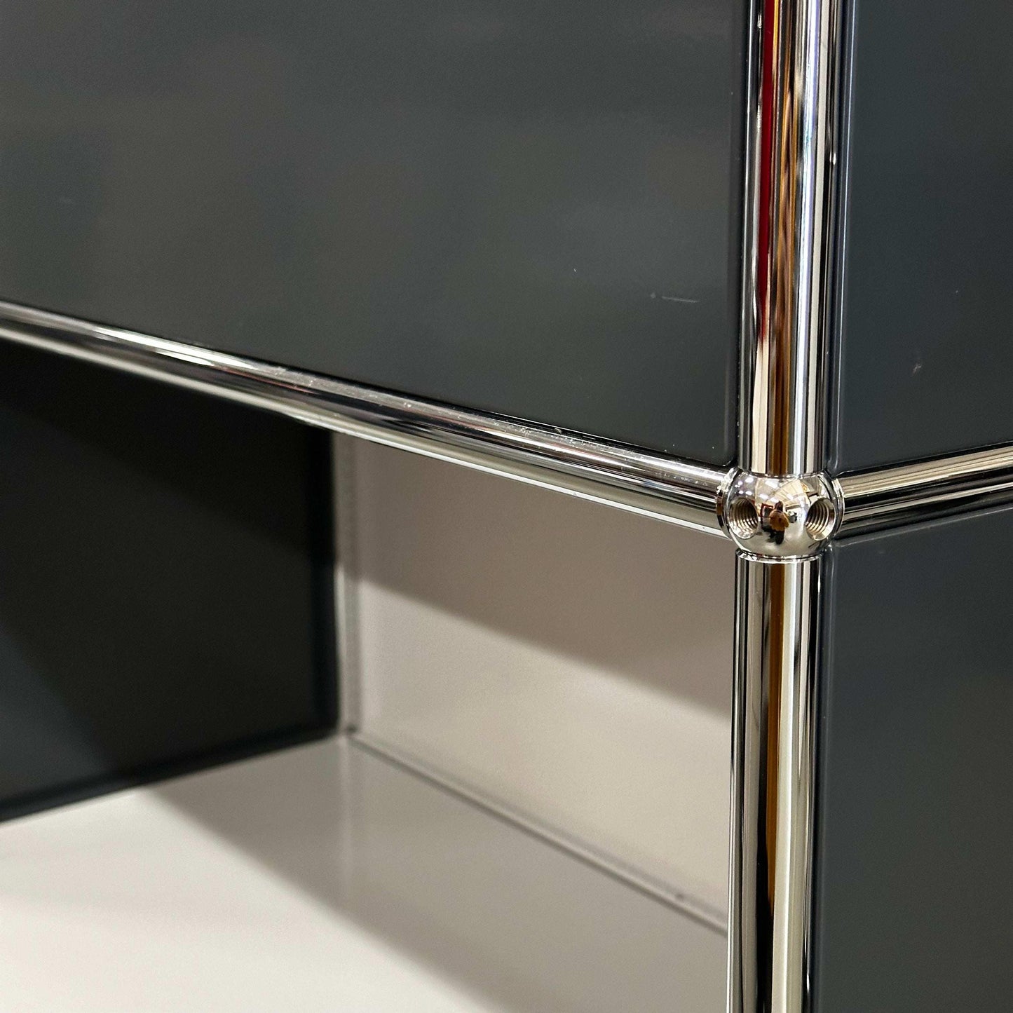 USM Haller High Board in light gray and anthracite with chrome frame detail