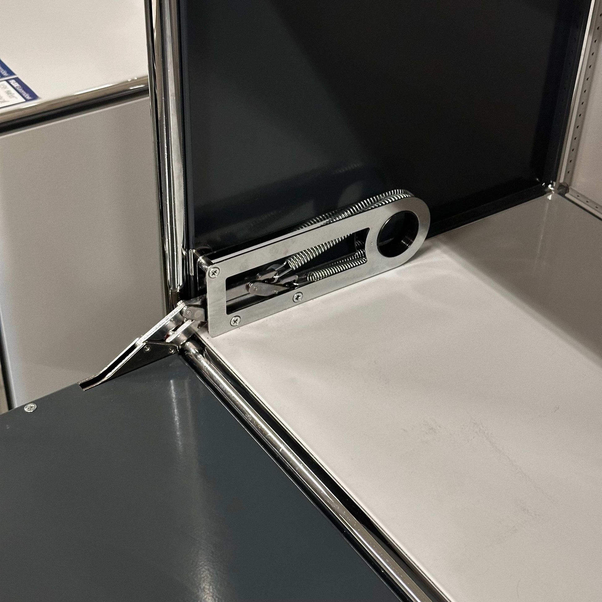 USM Haller High Board in light gray and anthracite colors with metal hinge detail interior view