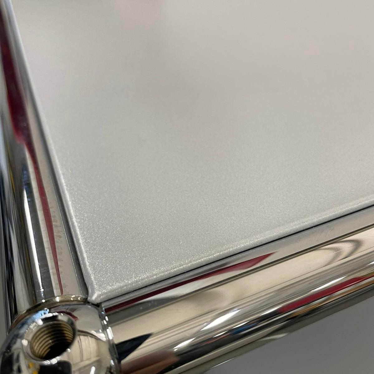 Close-up of USM Haller highboard corner in matte silver with chrome frame, like new condition