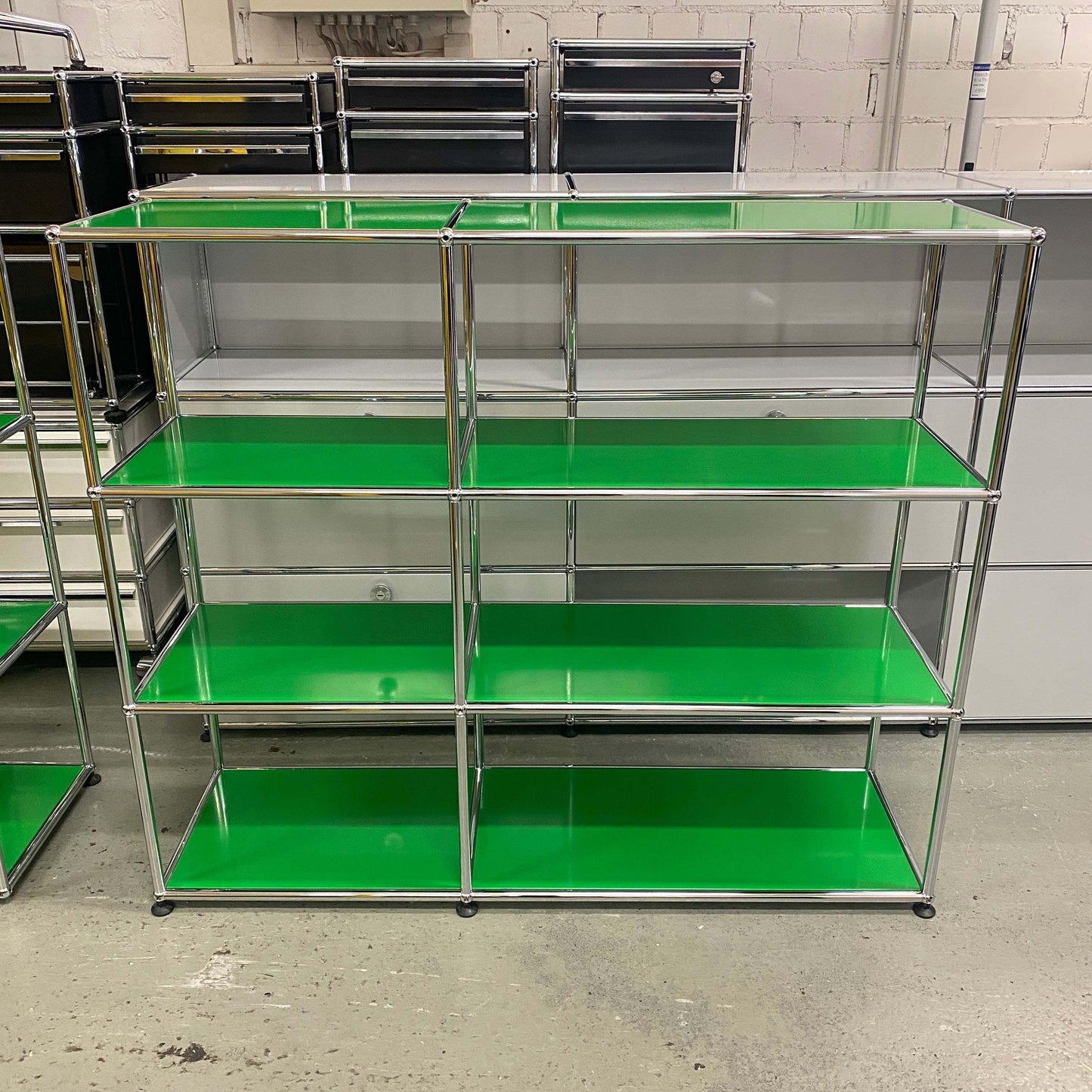 USM Haller Highboard with green open shelves and chrome frame, measuring 128x109x38cm