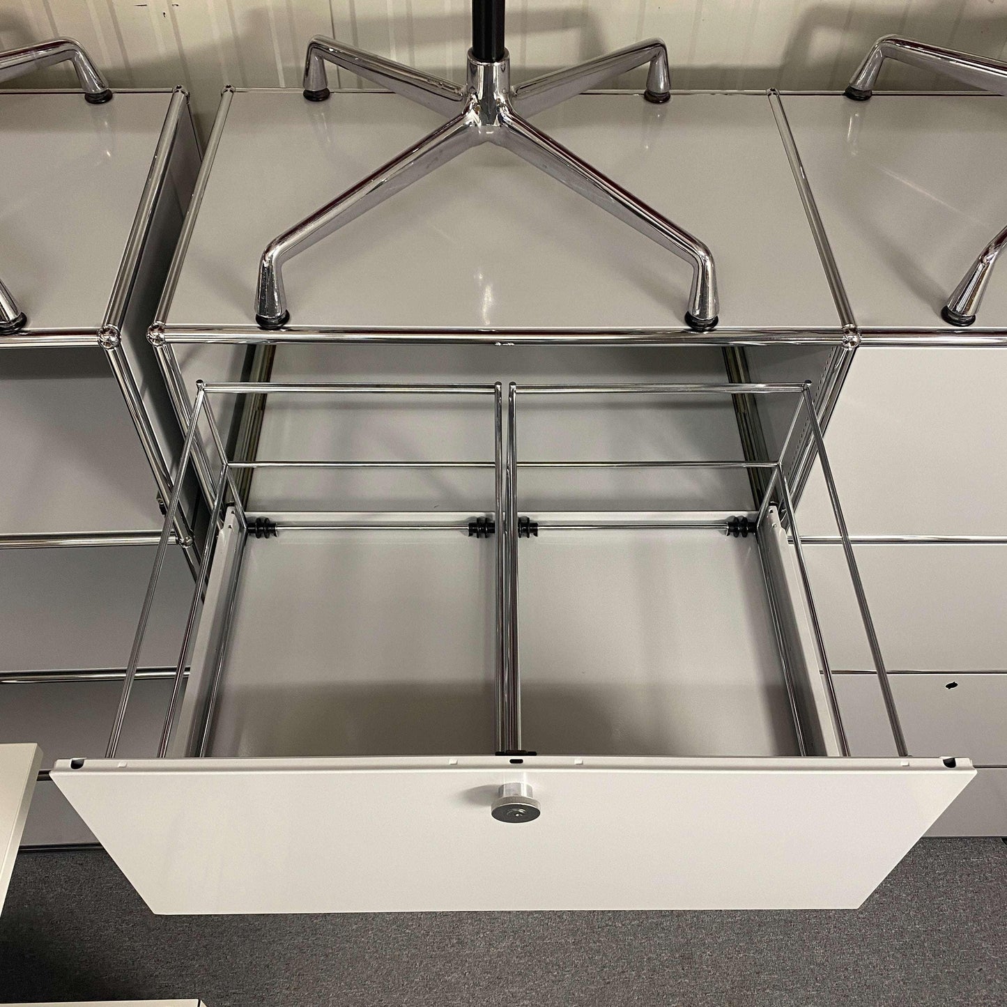 USM Haller Highboard in light gray with open hanging file drawer and metal frame