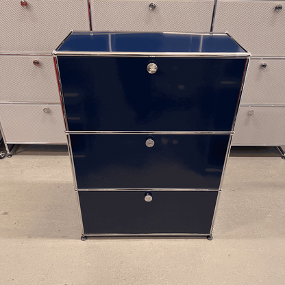 USM Haller highboard in steel blue with three flap compartments and chrome frame, dimensions 109x78x38 cm.