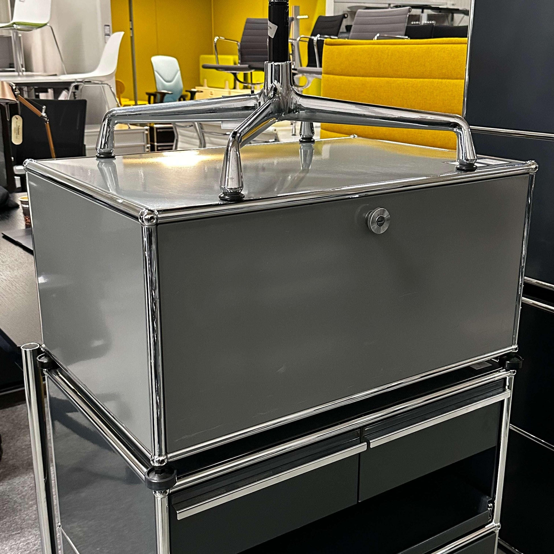 USM Haller lowboard in medium gray with one flap door and chrome frame, modern storage unit