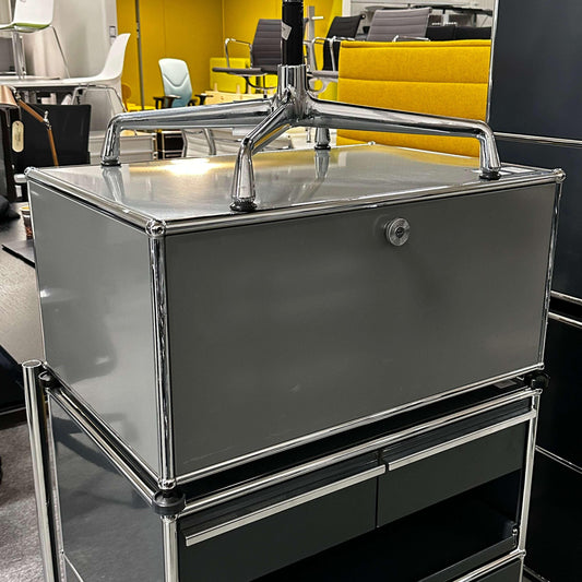 USM Haller lowboard in medium gray with one flap door and chrome frame, modern storage unit