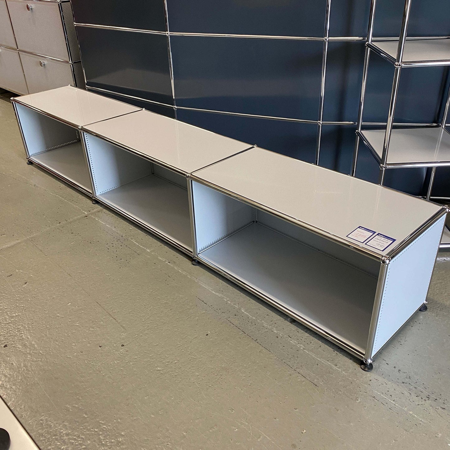 USM Haller Lowboard in light gray with three open compartments and 228x38x38cm dimensions