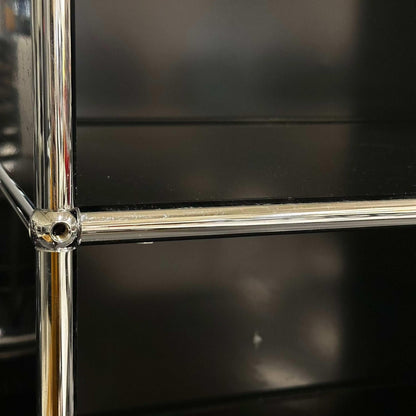 Close-up of black USM Haller Regal 1x6 shelves with chrome frame