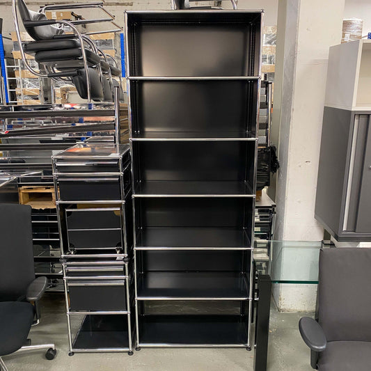 Black USM Haller Regal shelving unit with six shelves and metal frame, 214x78x38cm tall in storage room.