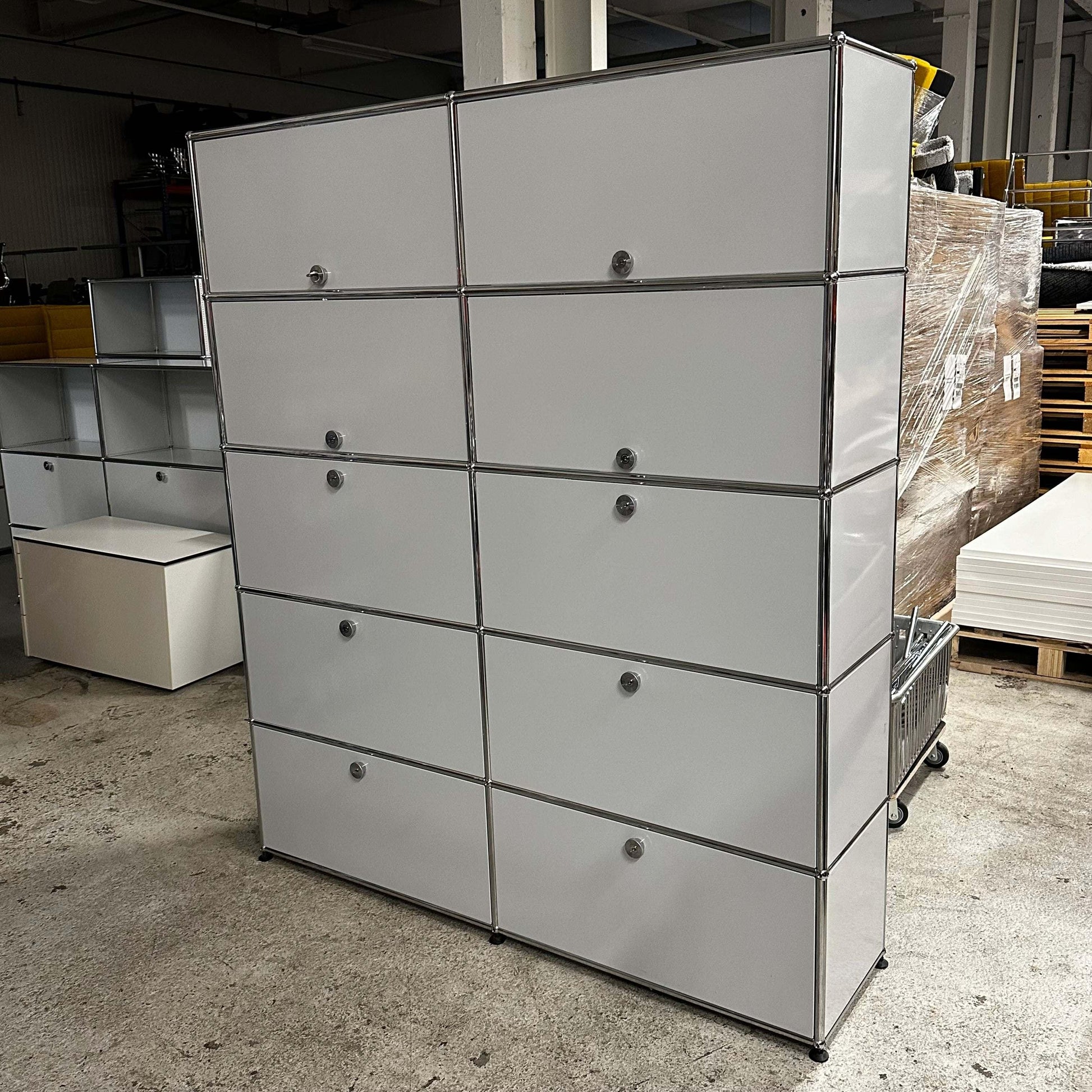 USM Haller Regal in light gray with large steel modular compartments for versatile storage and elegant modern design