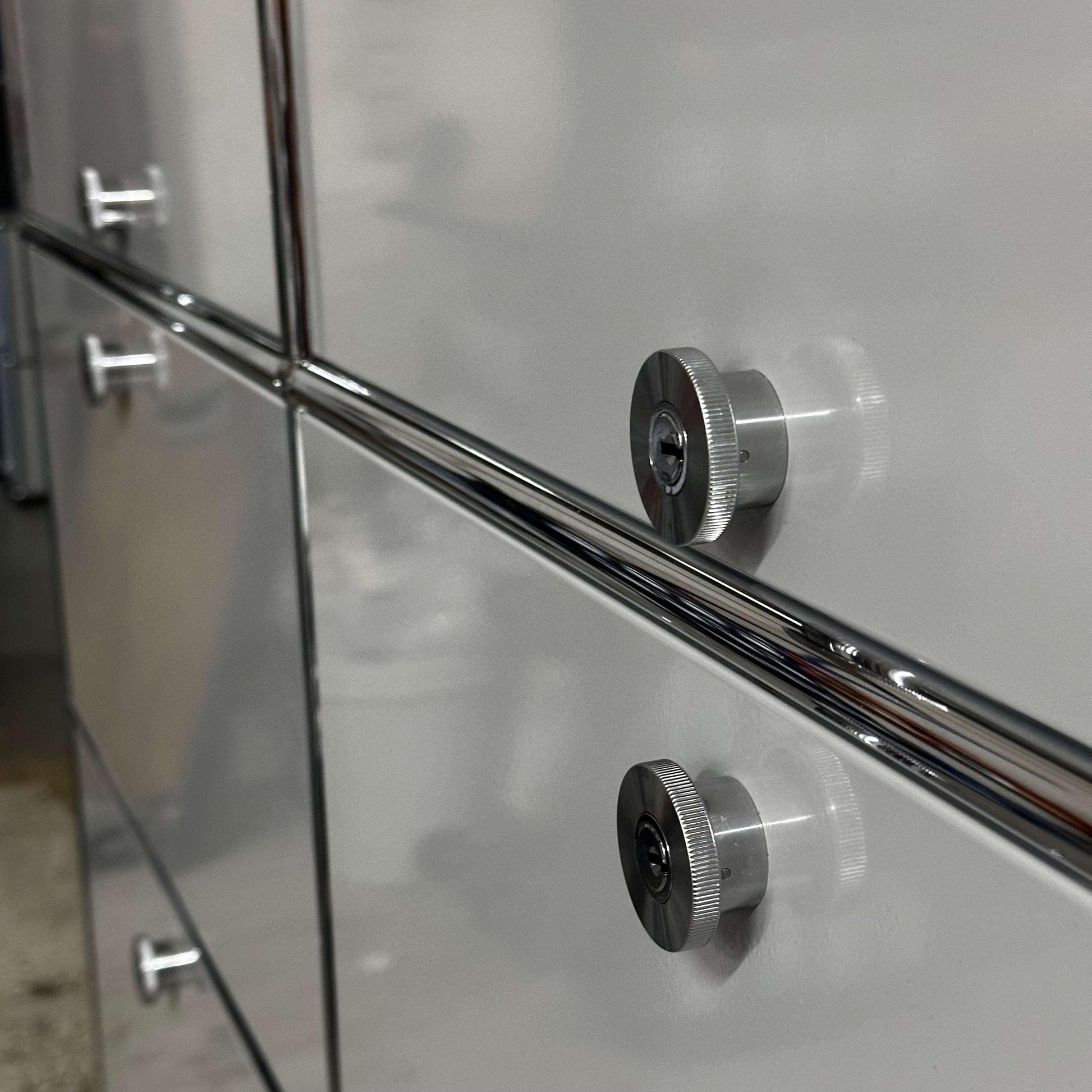 Close-up of light gray USM Haller Regal cabinet with metal knobs and steel construction.