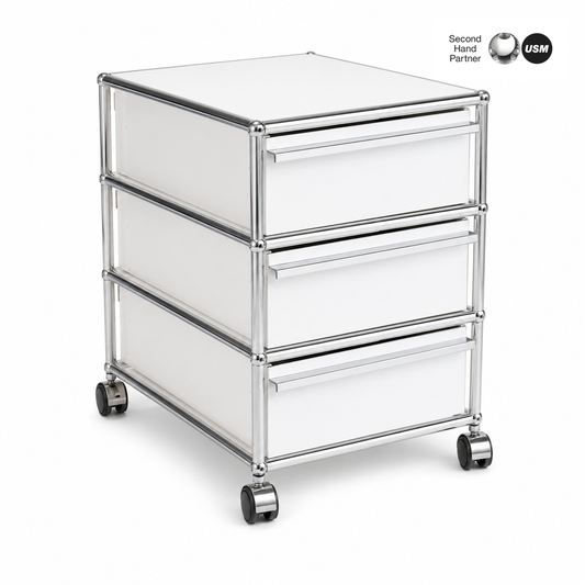 USM Haller Rollcontainer reinweiß mit 3 Schubladen, Chromgestell und Rollen.