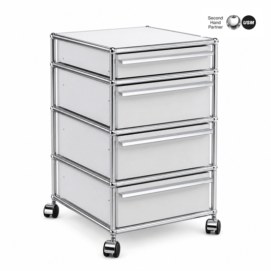USM Haller Rollcontainer mit 4 lichtgrauen Schubladen, Chromgestell und Rollen.