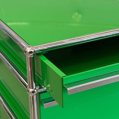 USM Haller Rollcontainer in green with three drawers and chrome frame details