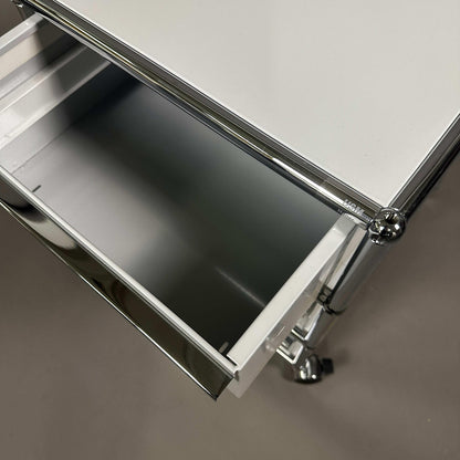 USM Haller light grey rollcontainer with three drawers and chrome frame on wheels