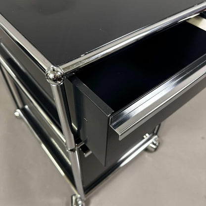 USM Haller Rollcontainer in graphite black with two drawers and chrome frame detail