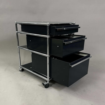 USM Haller Rollcontainer black with three drawers and chrome frame on wheels