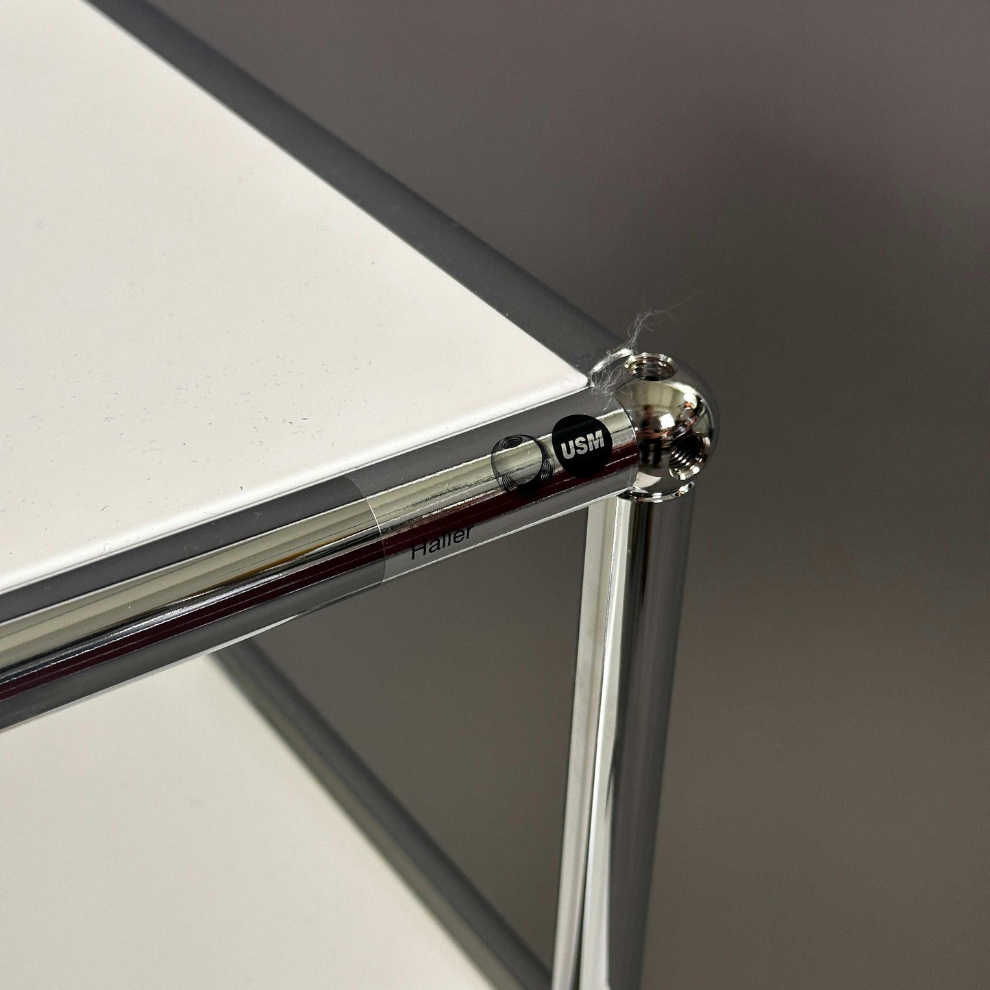 USM Haller Sideboard weiß mit Klappe und Chromrahmen nahaufnahme