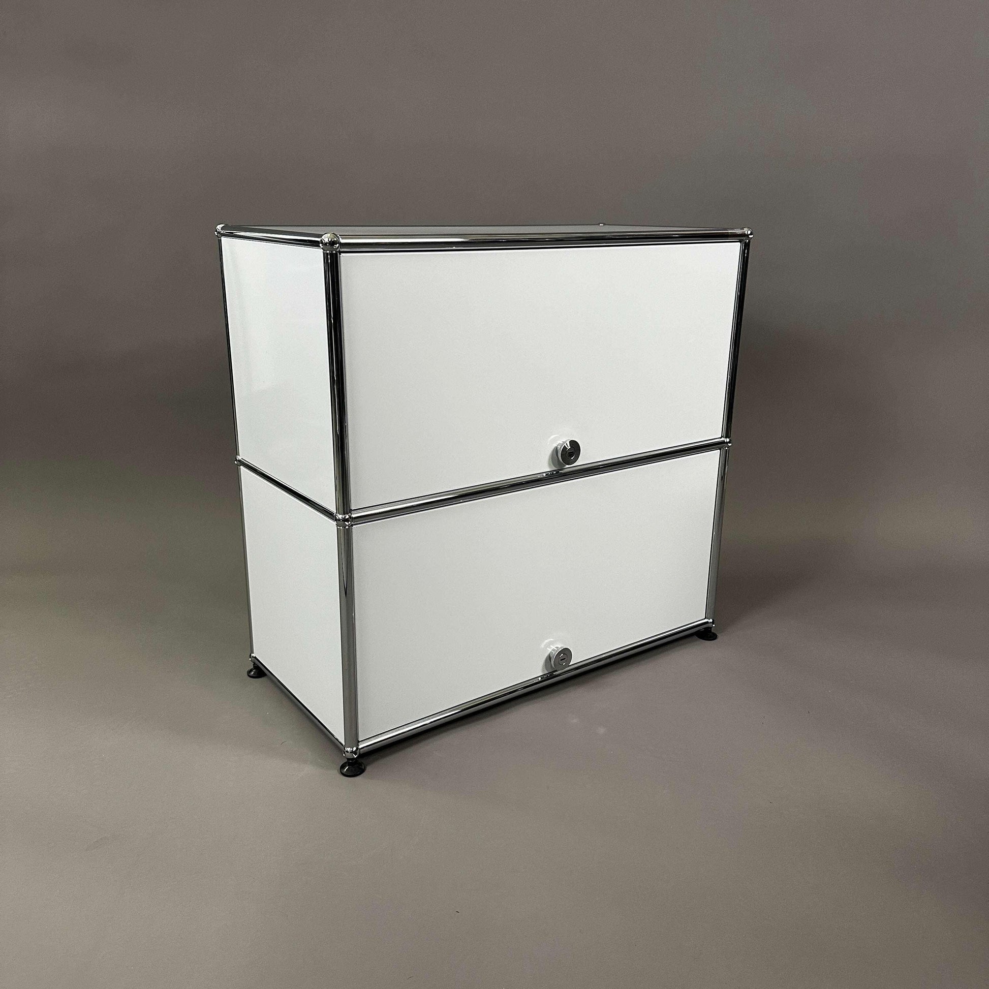 USM Haller light gray sideboard with two sliding doors and metal frame against neutral background