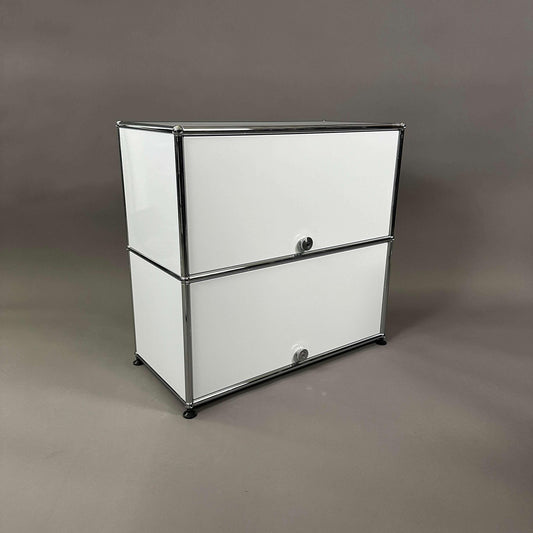 USM Haller light gray sideboard with two sliding doors and metal frame against neutral background