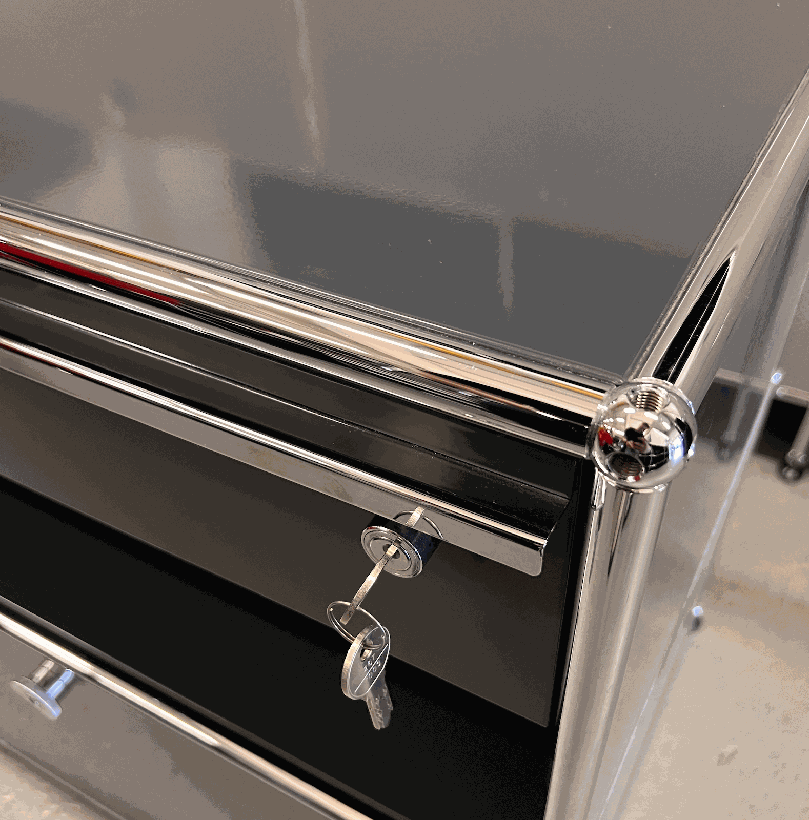 Close-up of anthracite USM Haller Sideboard with keys in lock and chrome frame detailing