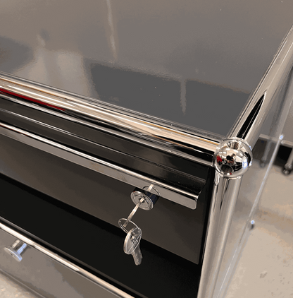 Close-up of anthracite USM Haller Sideboard with keys in lock and chrome frame detailing