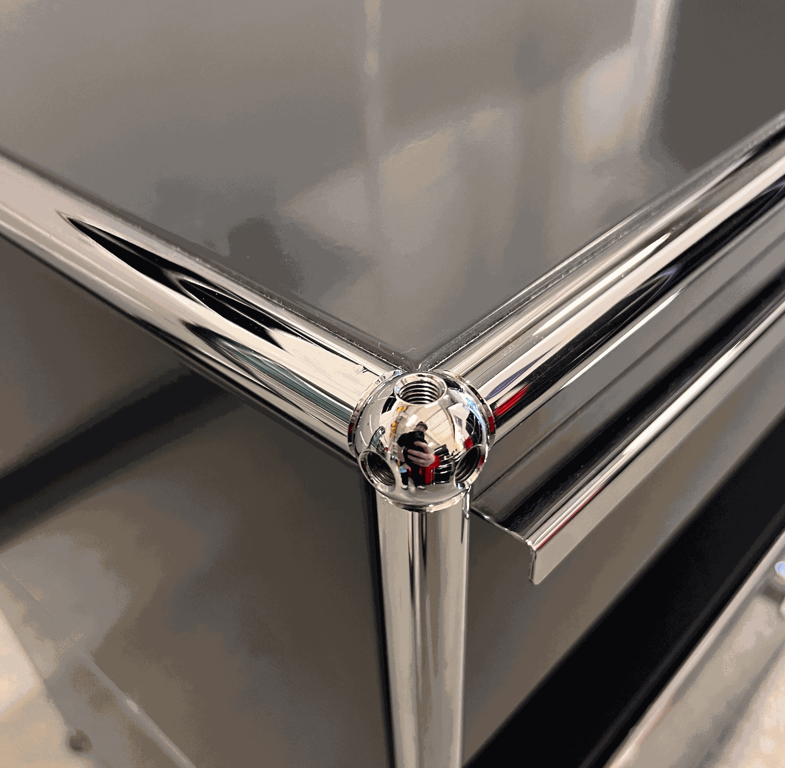 Close-up of chrome corner detail on anthracite USM Haller Sideboard with drawers and pull-out compartment