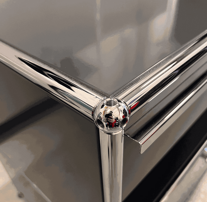 Close-up of chrome corner detail on anthracite USM Haller Sideboard with drawers and pull-out compartment