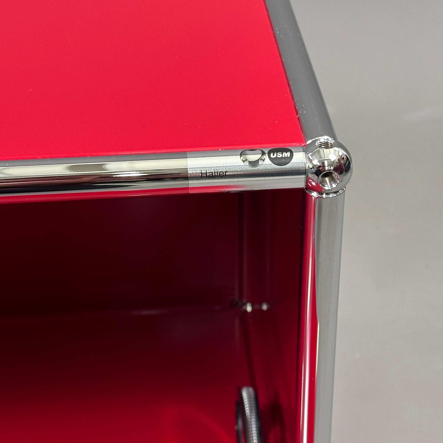 USM Haller Sideboard rubinrot mit einer Klappe und verchromtem Stahlrahmen, modern und kompakt