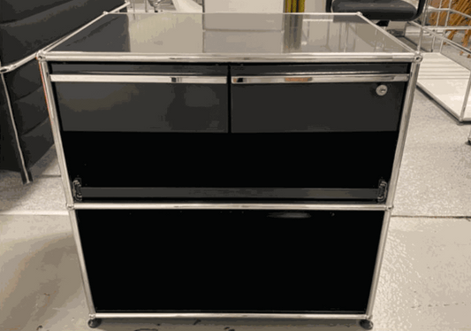 USM Haller Sideboard in graphite black with chrome frame, featuring drawers and a cabinet, modern and functional design.