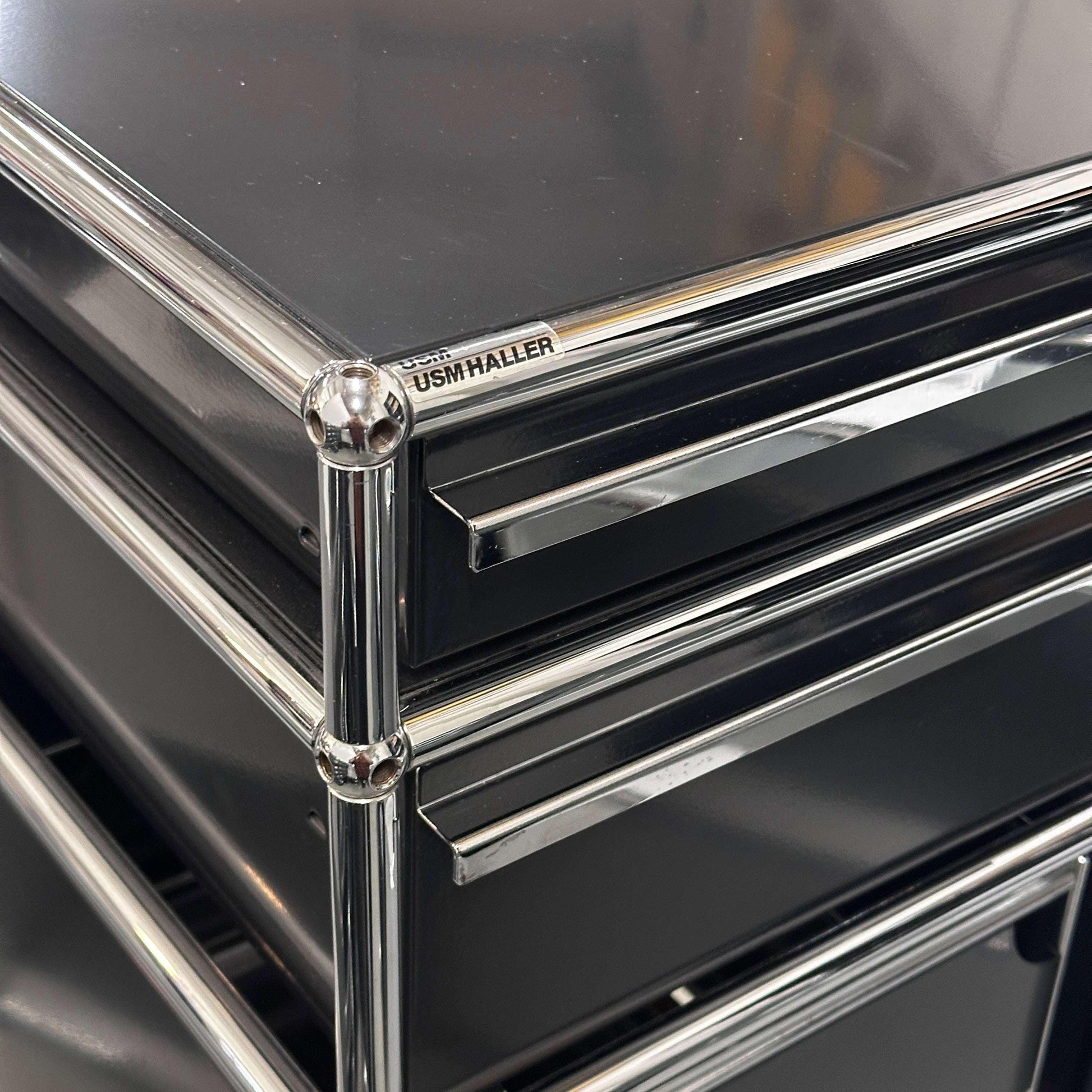 Close-up of black USM Haller Standcontainer with chrome frame and two drawers including hanging file compartment