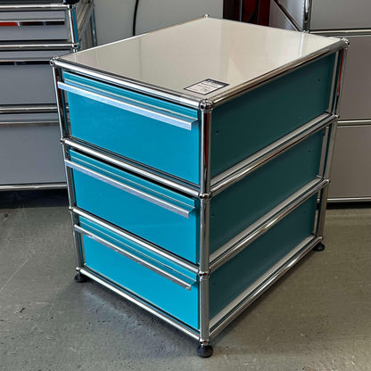 USM Haller Standcontainer in turquoise and light gray with three drawers and chrome frame