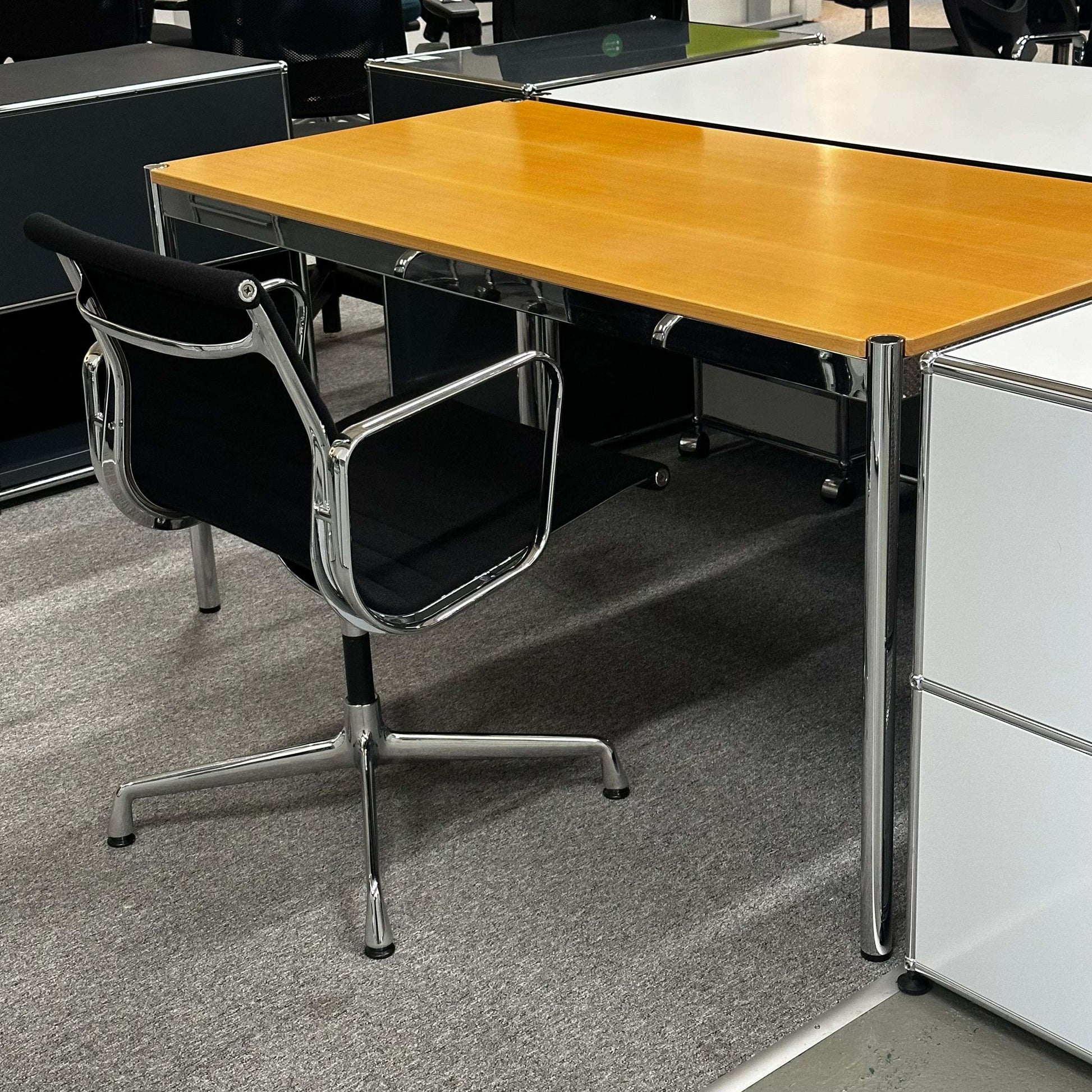 USM Haller Tisch 150x75cm with beech wood top and chrome frame in office setting