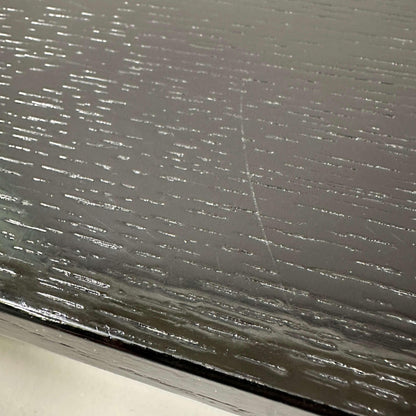 Close-up of black oak wood grain surface of USM Haller Tisch 150x75cm with smooth finish