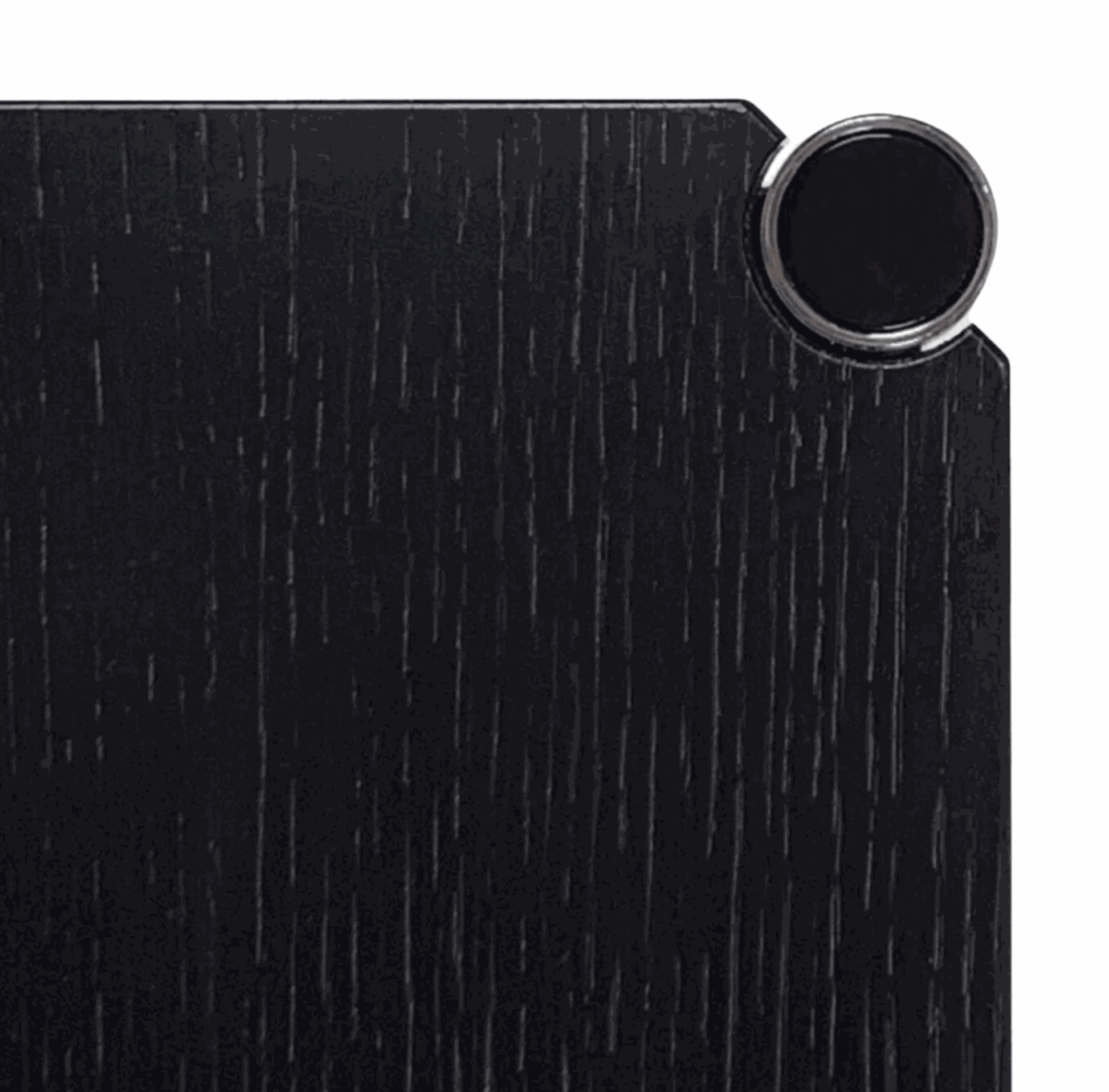 Close-up of black lacquered oak wood surface with chrome detail on USM Haller Tisch table