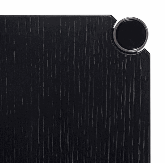 Close-up of black lacquered oak wood surface with chrome detail on USM Haller Tisch table
