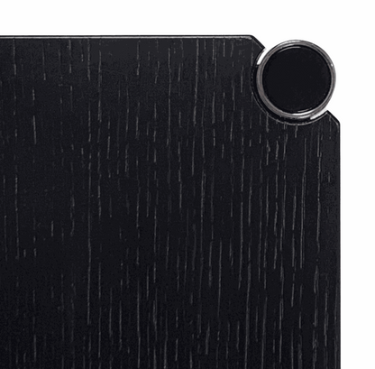 Close-up of black oak tabletop with chrome connector corner of USM Haller Tisch 75x75cm